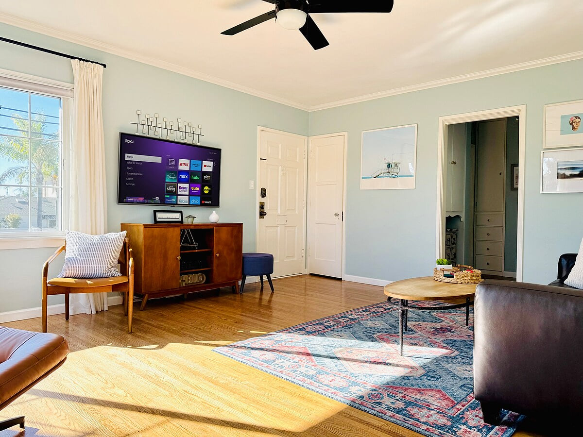 A light filled living room with TV equipped with Roku so you can access all of your streaming accounts. 