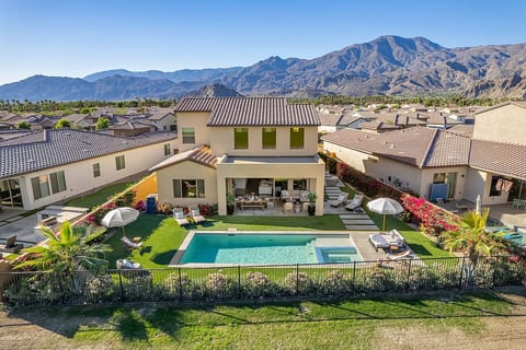 View of our beautiful home in a colorful oasis of Bougainvilleas and palms. Please note - since these photos taken Oct 23, the fence has been lowered to enhance the view