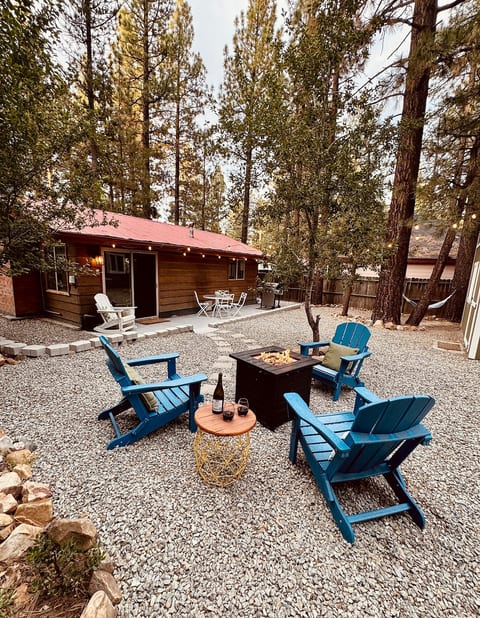 Gather around the fire pit beneath string lights and tall pines for relaxed evenings outdoors. Toast s’mores, share a drink, and enjoy the fresh mountain air in the fenced backyard.