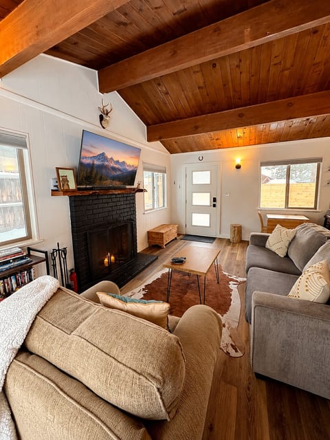 Sun filled main living space with an open layout, cozy textures, and a relaxed cabin feel. Ideal for morning coffee, evening wind down, or gathering for games and conversation after a day exploring Big Bear.