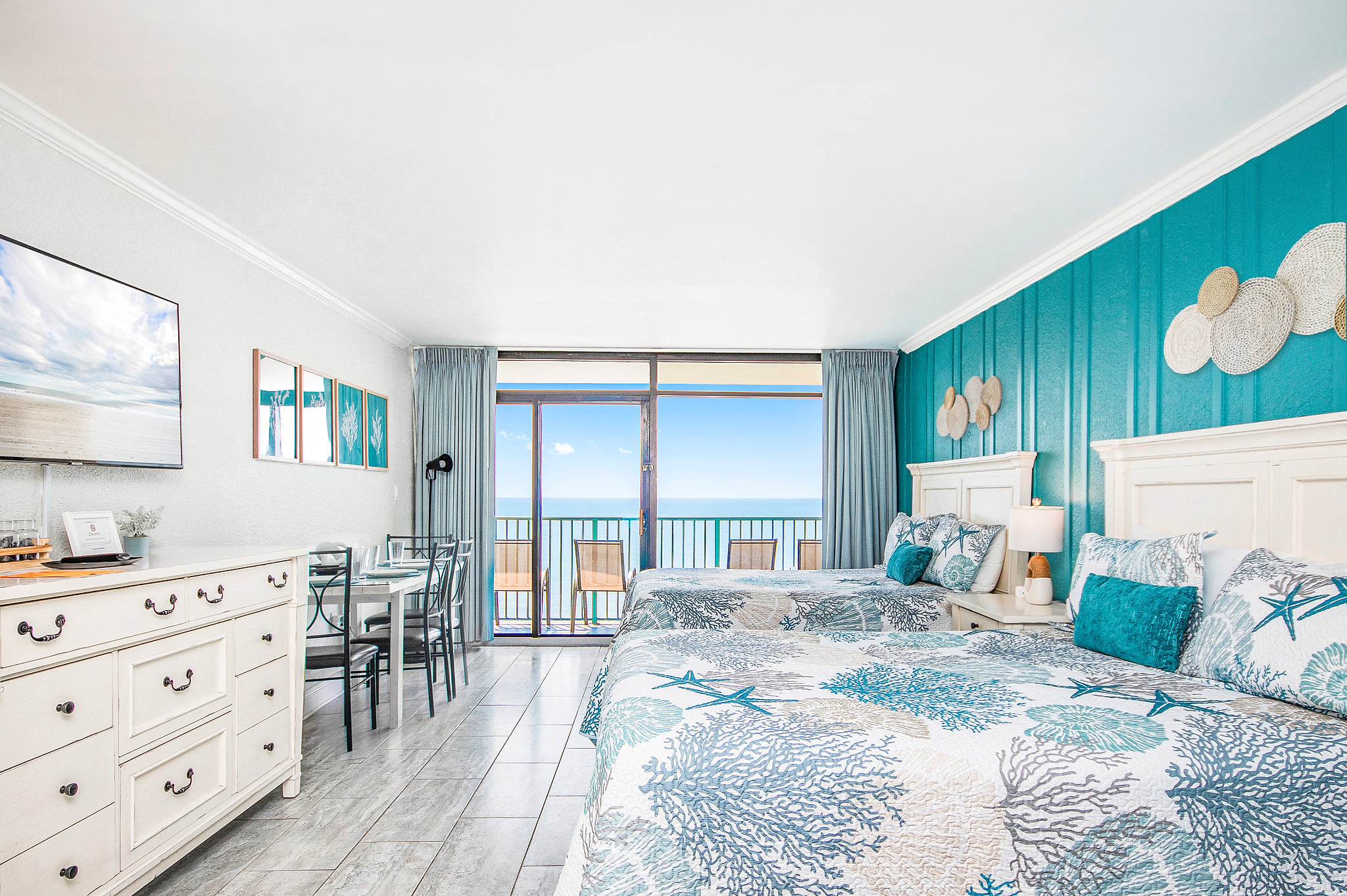 Bright oceanfront studio with balcony, two queen beds, coastal charm