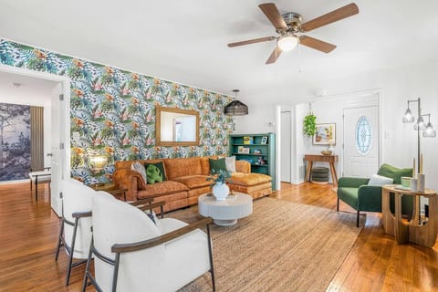 Our spacious living room features plush couches, fun board games, and a soothing ceiling fan—perfect for your cozy getaway. Relax, play, and create memories!