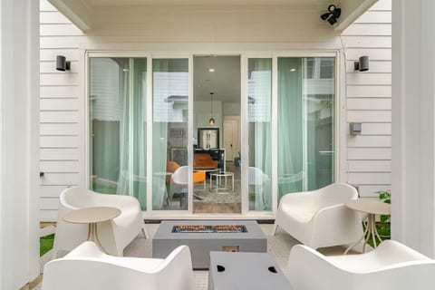 Covered patio with modern lounge seating and sleek fire pit—perfect evenings.