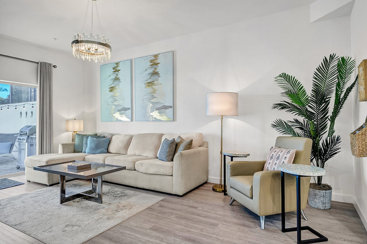 Gather, relax, and recharge in this open-concept living room, featuring a plush L-shaped sofa and plenty of space for everyone to feel at home including large smart TV.   