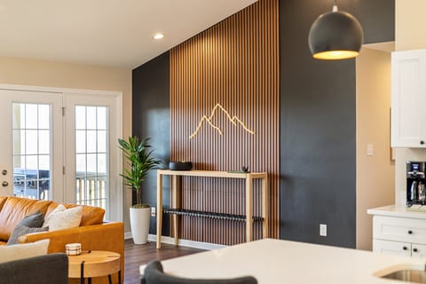 Bright modern living space with slat wall art and patio access