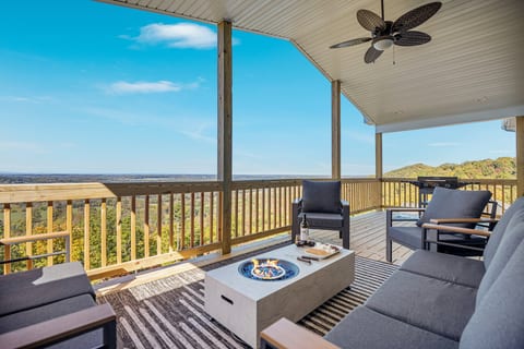 Covered deck with fire pit, lounge seating & sweeping mountain views