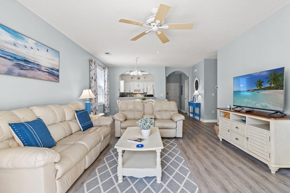 Welcome to your coastal escape at Cypress Bend in Barefoot Resort. This sunny open-concept condo features a comfortable living room with plush leather seating, new SMART TV, and a balcony right off the living room.
