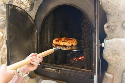 Make your own authentic pizza in the indoor wood fired masonry oven right in the kitchen!