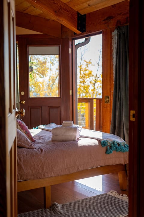 Second Queen bedroom just off of the living room/kitchen area opens up to the deck for private views and deck lounging