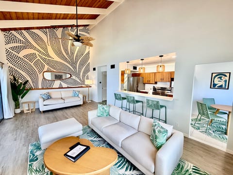 Bright vaulted living w/ bold mural, bar seating & modern kitchen