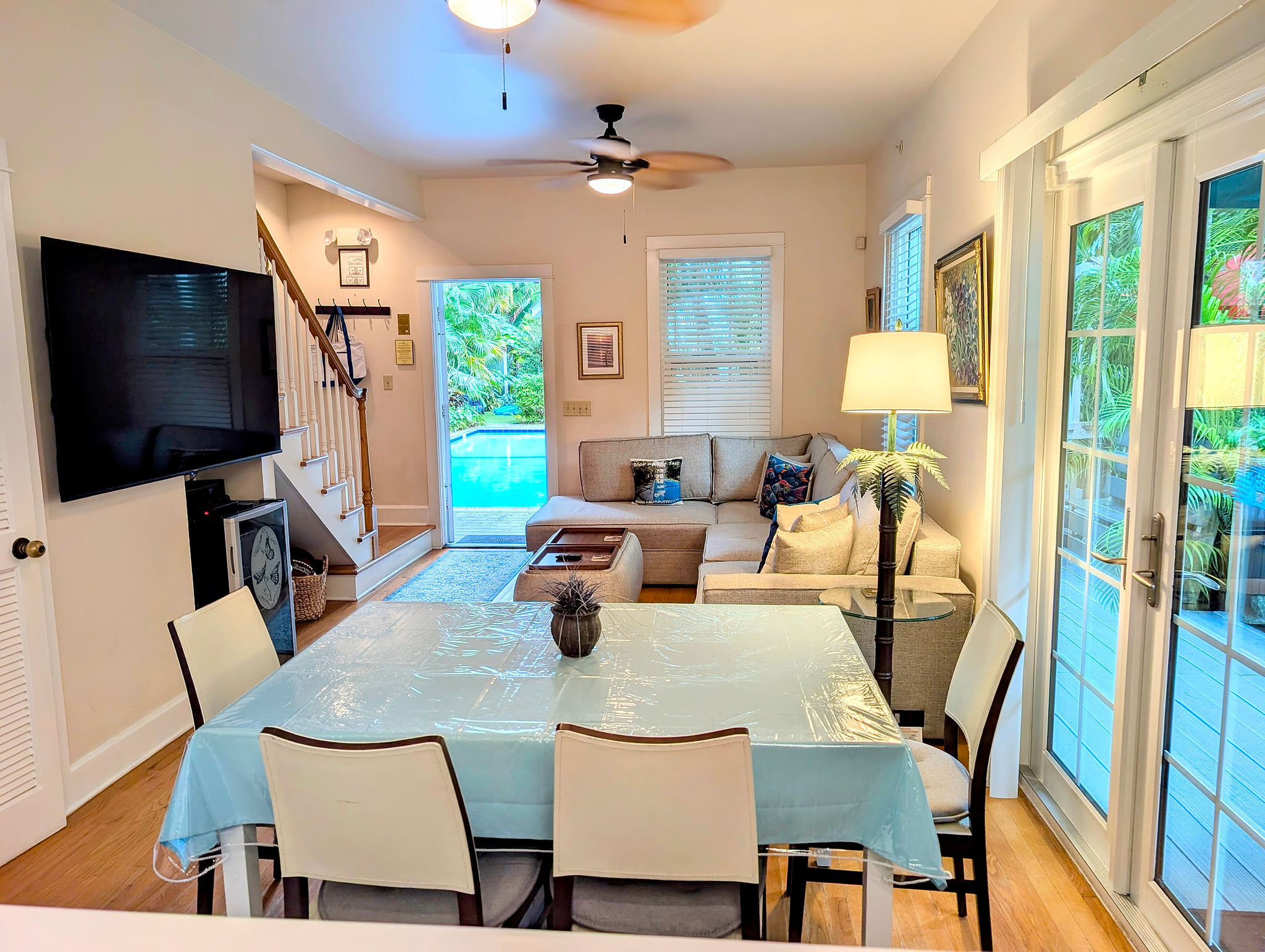 Bright open-plan lounge with French doors to pool and dining for six.