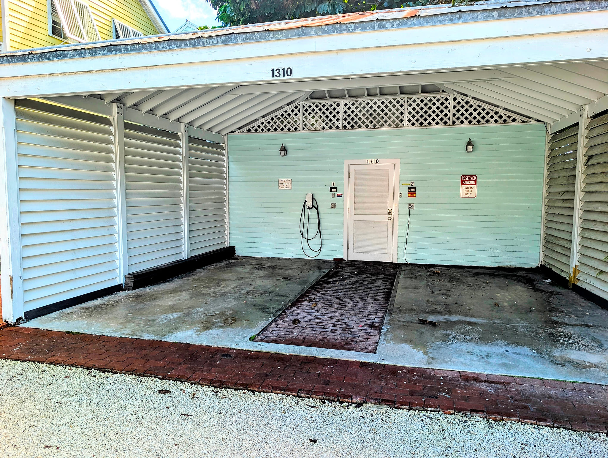 Shaded private carport with secure entry and convenient rinse hose