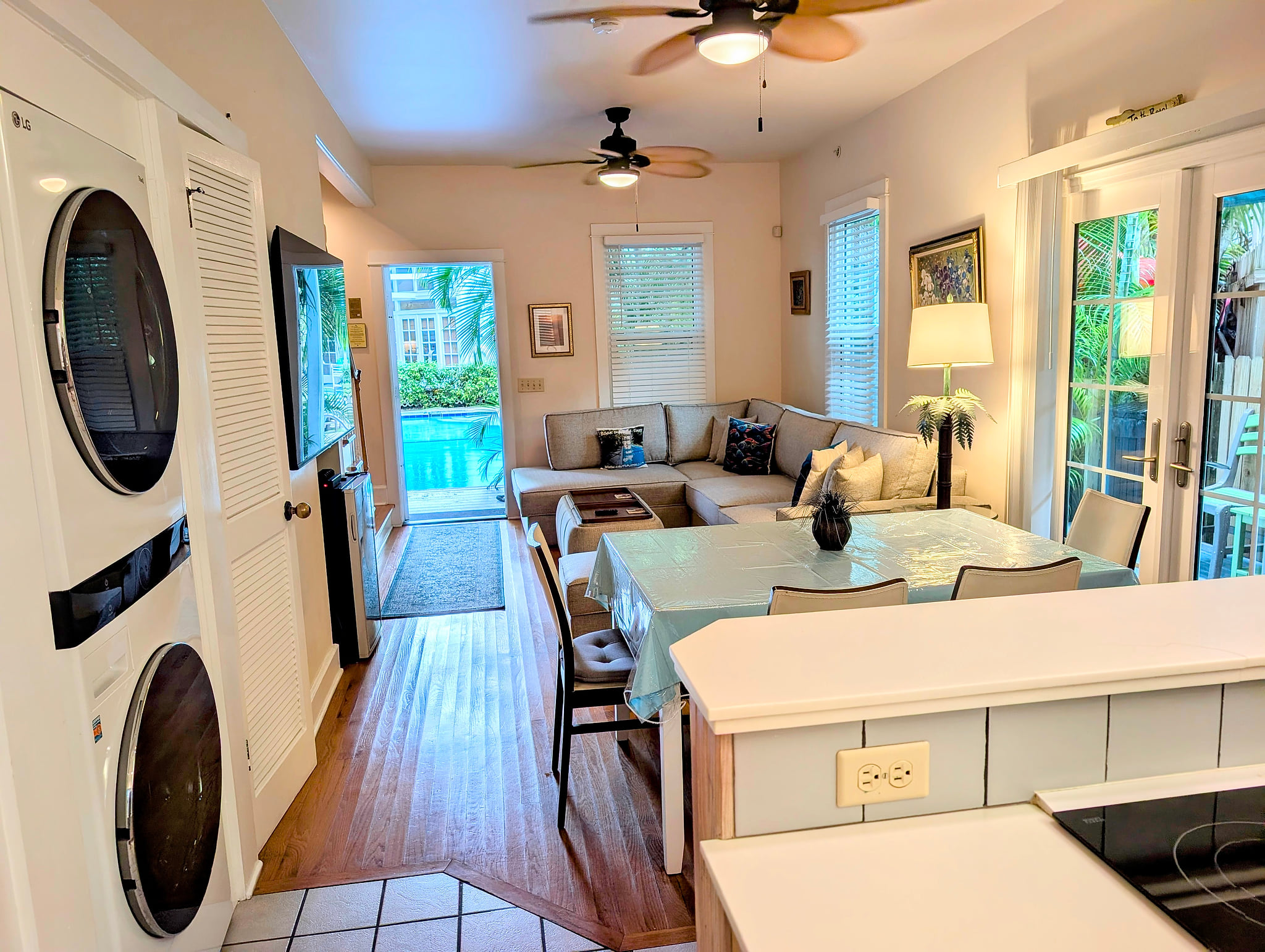Sunny poolside retreat with open living, French doors, and washer/dryer