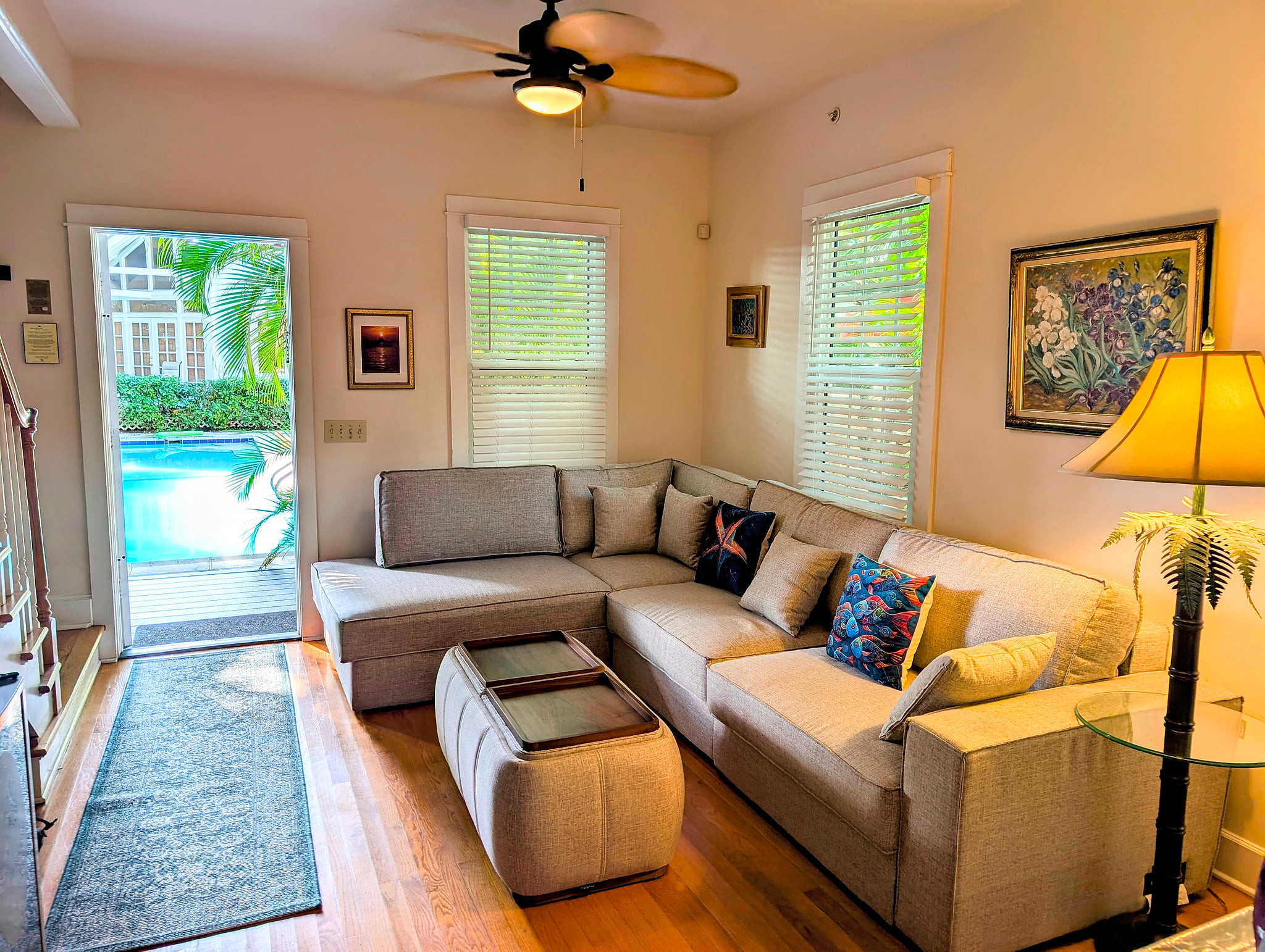 Sunny lounge with sectional and poolside access—relax and unwind.