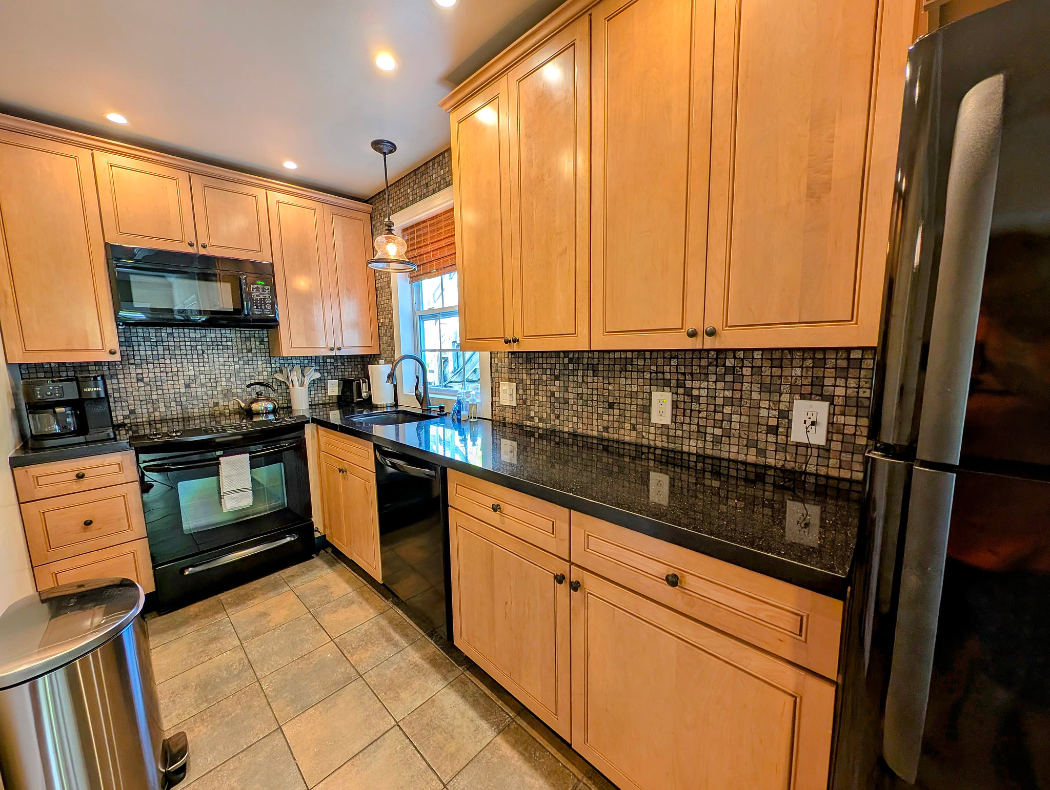 Modern kitchen with granite counters, mosaic backsplash & full appliances
