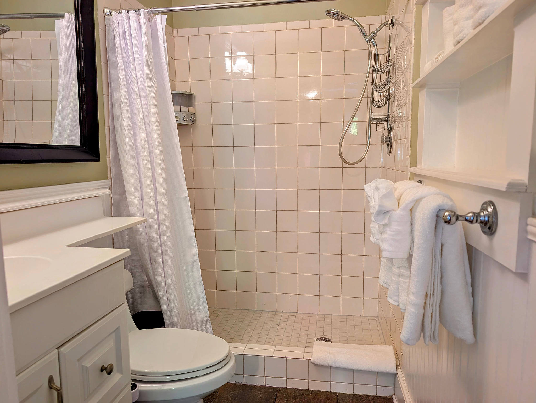 Bright, spotless bath with walk-in shower, plush towels, and ample storage.