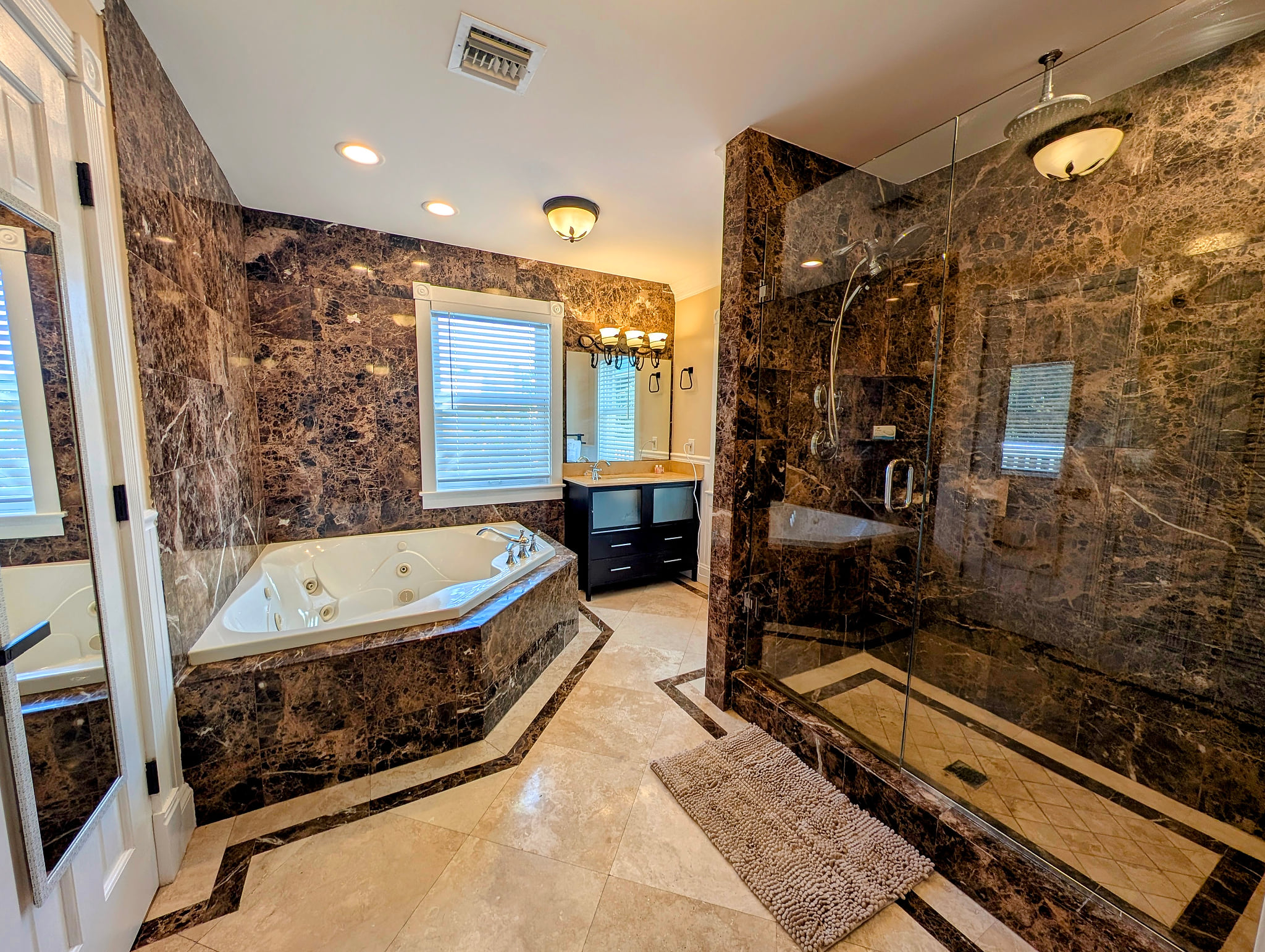Spa-like tub, huge walk-in dual rain shower, marble finishes