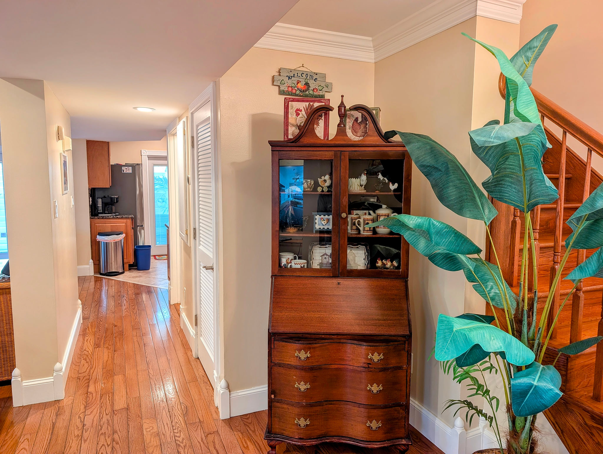 Warm hallway with antique charm, hardwood floors, and hallway to kitchen