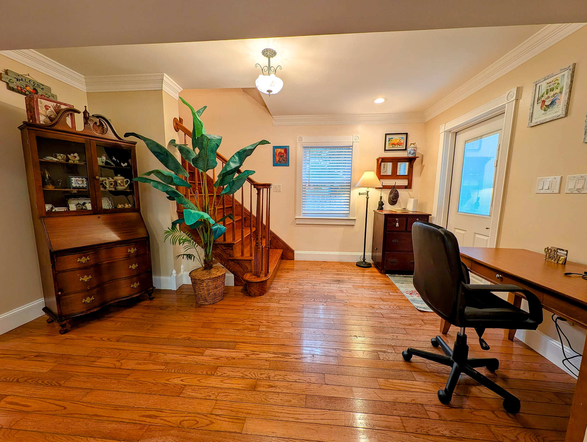 Bright entry with classic charm, hardwood floors, and a handy workspace.
