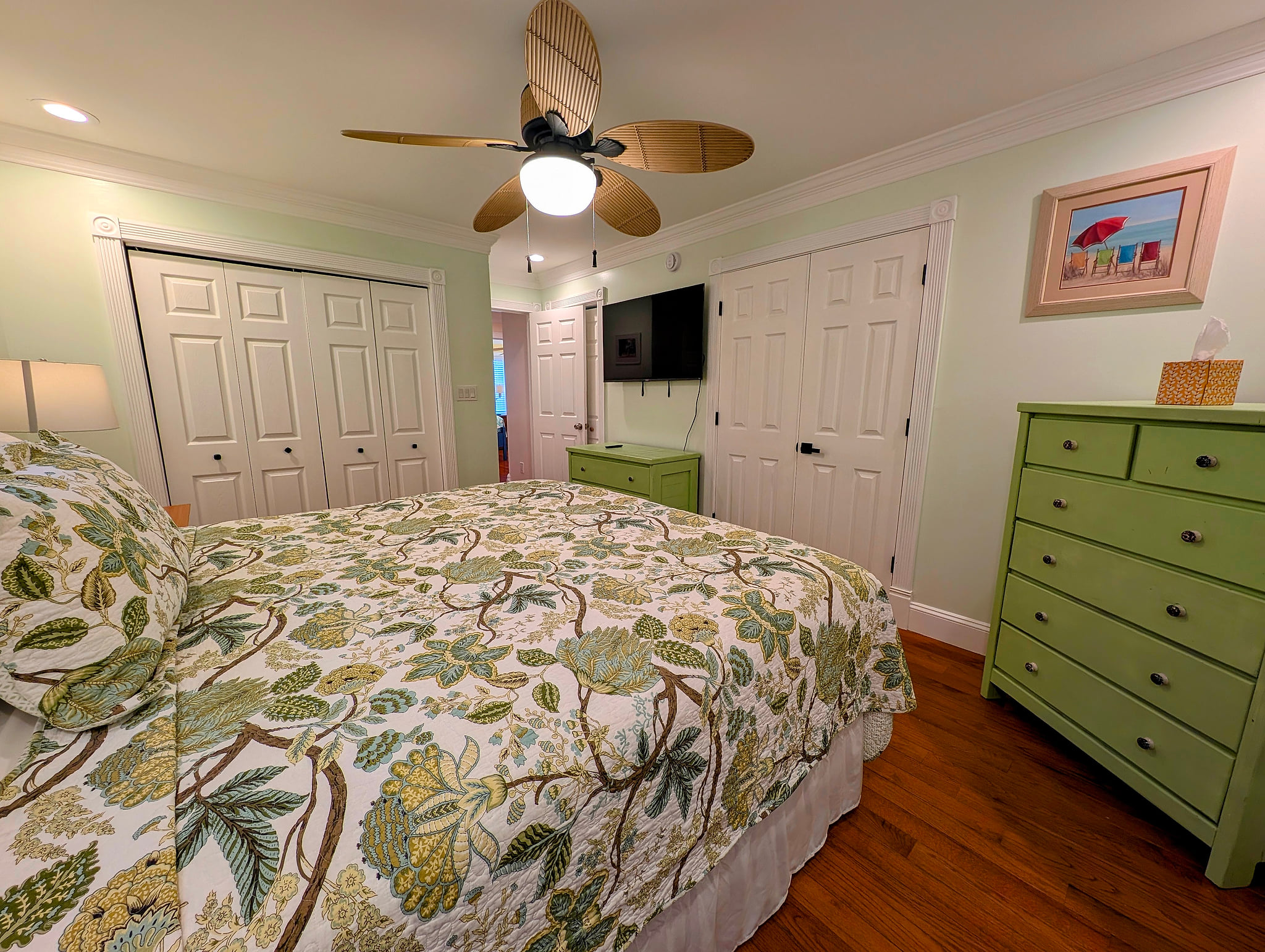 Master on suite coastal bedroom with king bed, 50 inch smart TV, ceiling fan, hardwoods and double closet