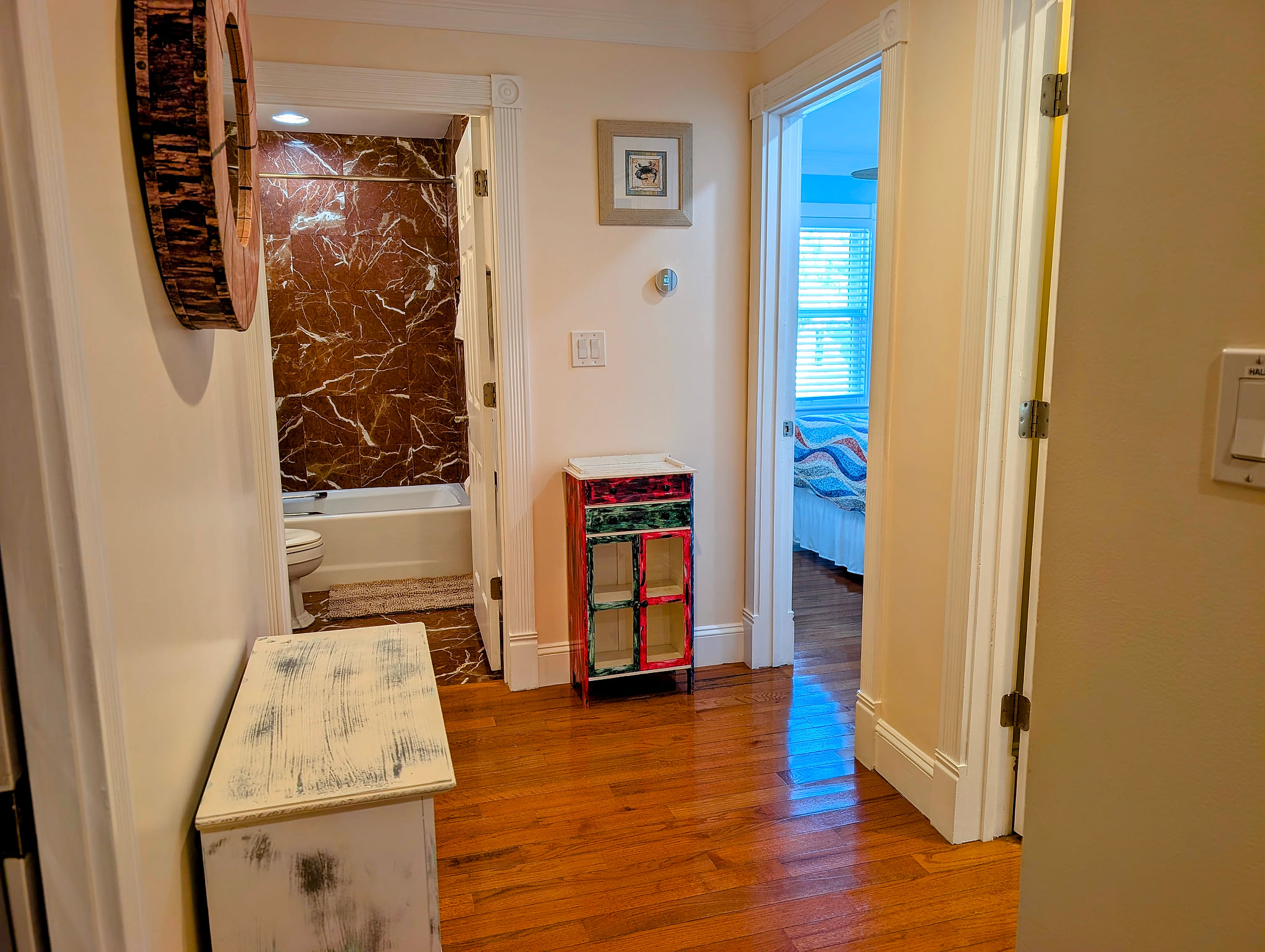 Second floor bright hallway with marble bath, hardwood floors, and three cozy bedrooms