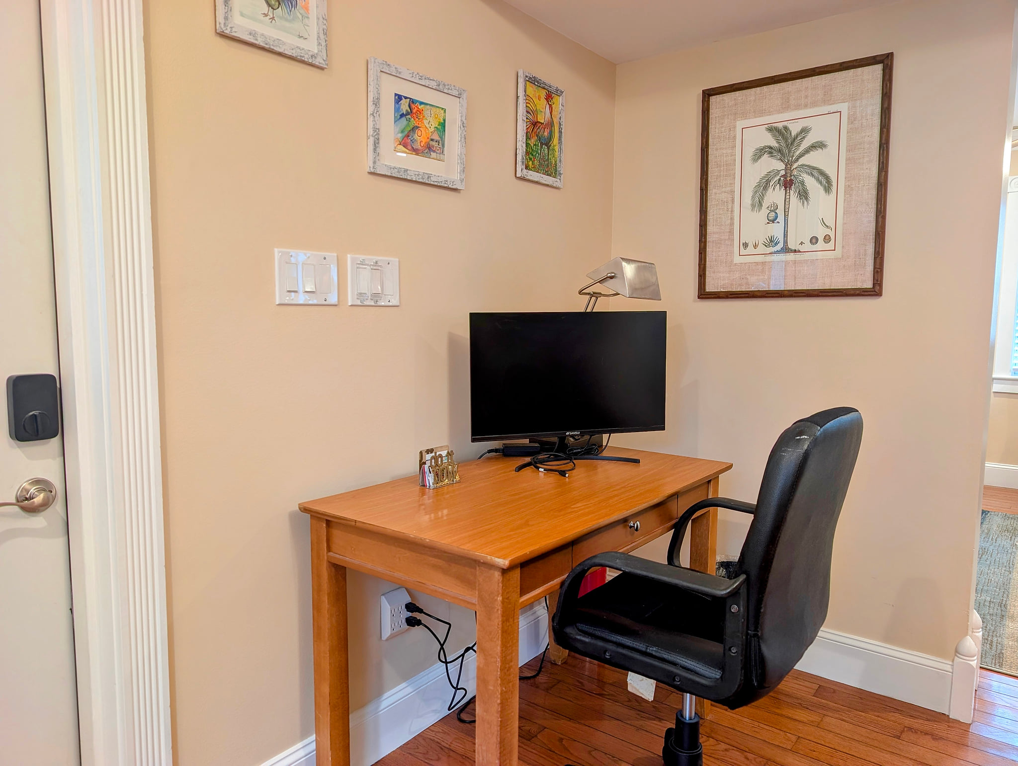 Cozy work nook with monitor, task lamp, and cushy office chair