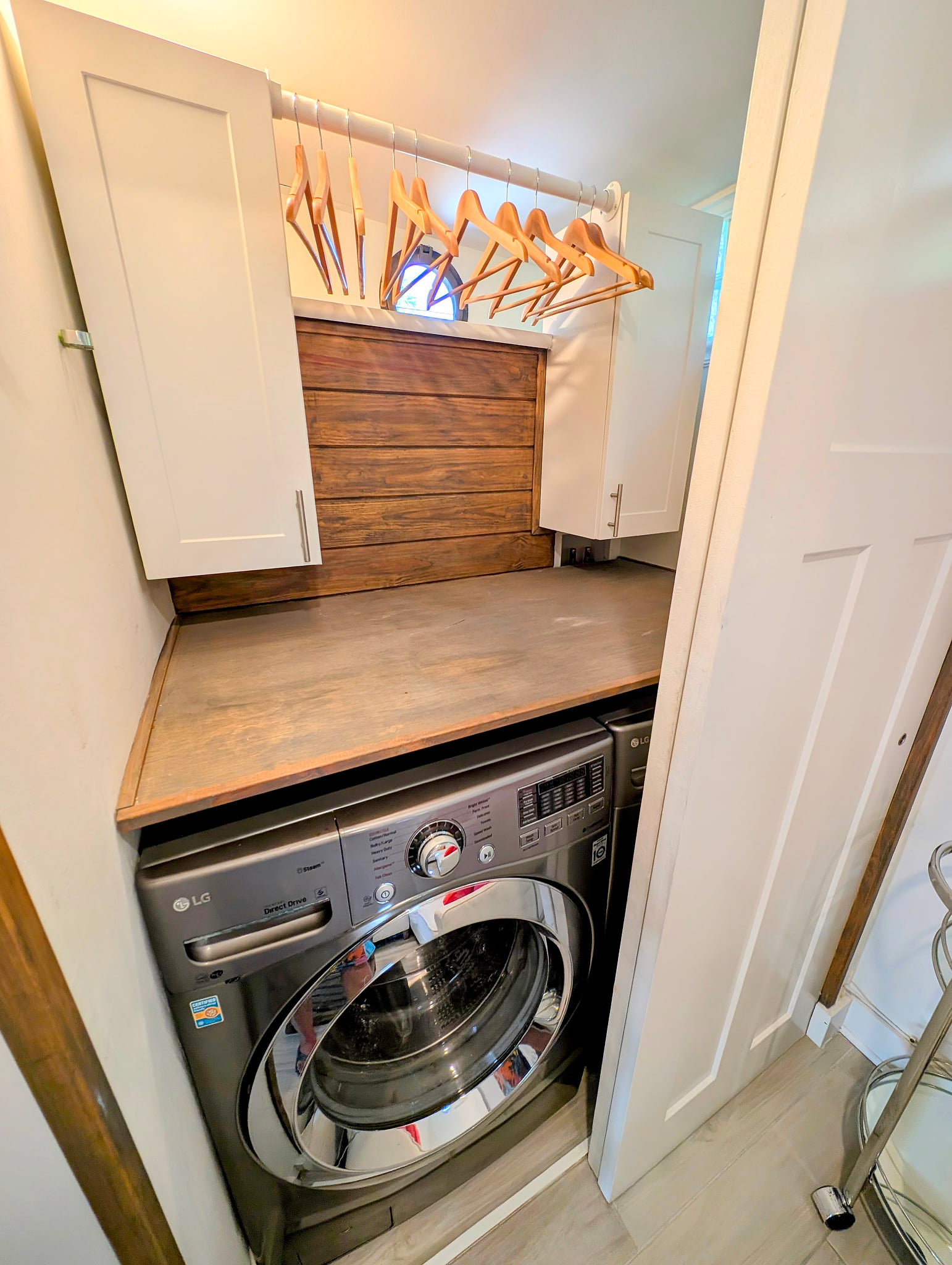 In-unit laundry nook with folding counter, storage and hang space