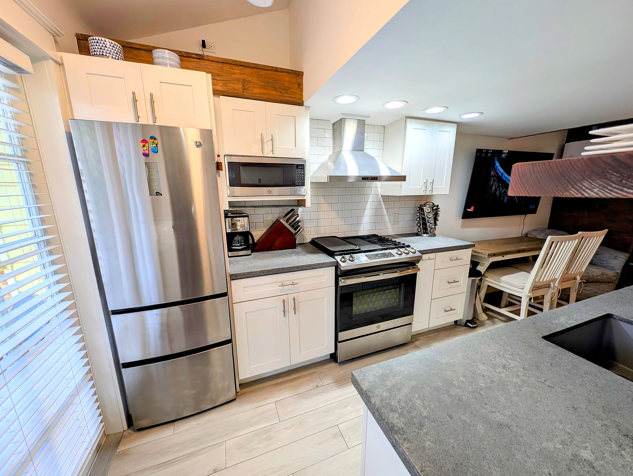 Bright modern kitchen with stainless suite, gas range, and dining nook Beach House Modern Old Town Studio Near Duval