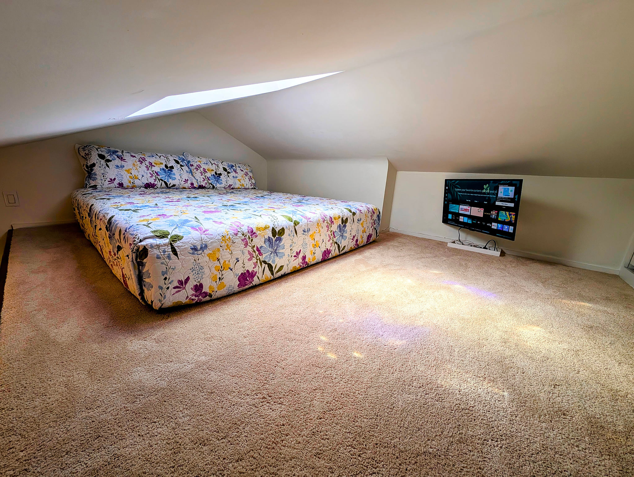 Cozy loft retreat with skylight, king floor bed & smart TV nook