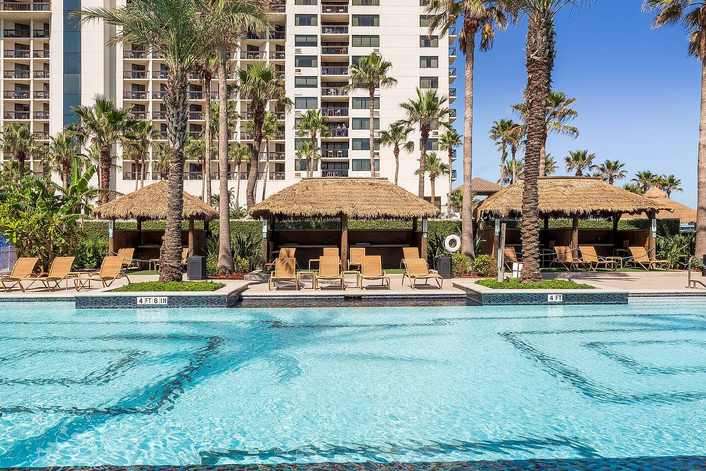 Stunning resort pool with palm trees and ocean breezes, your daily paradise.