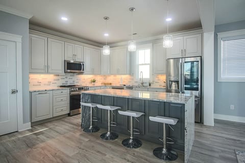 Open floor plan living and dining area and kitchen. Fully stocked kitchen with basic cooking utensils