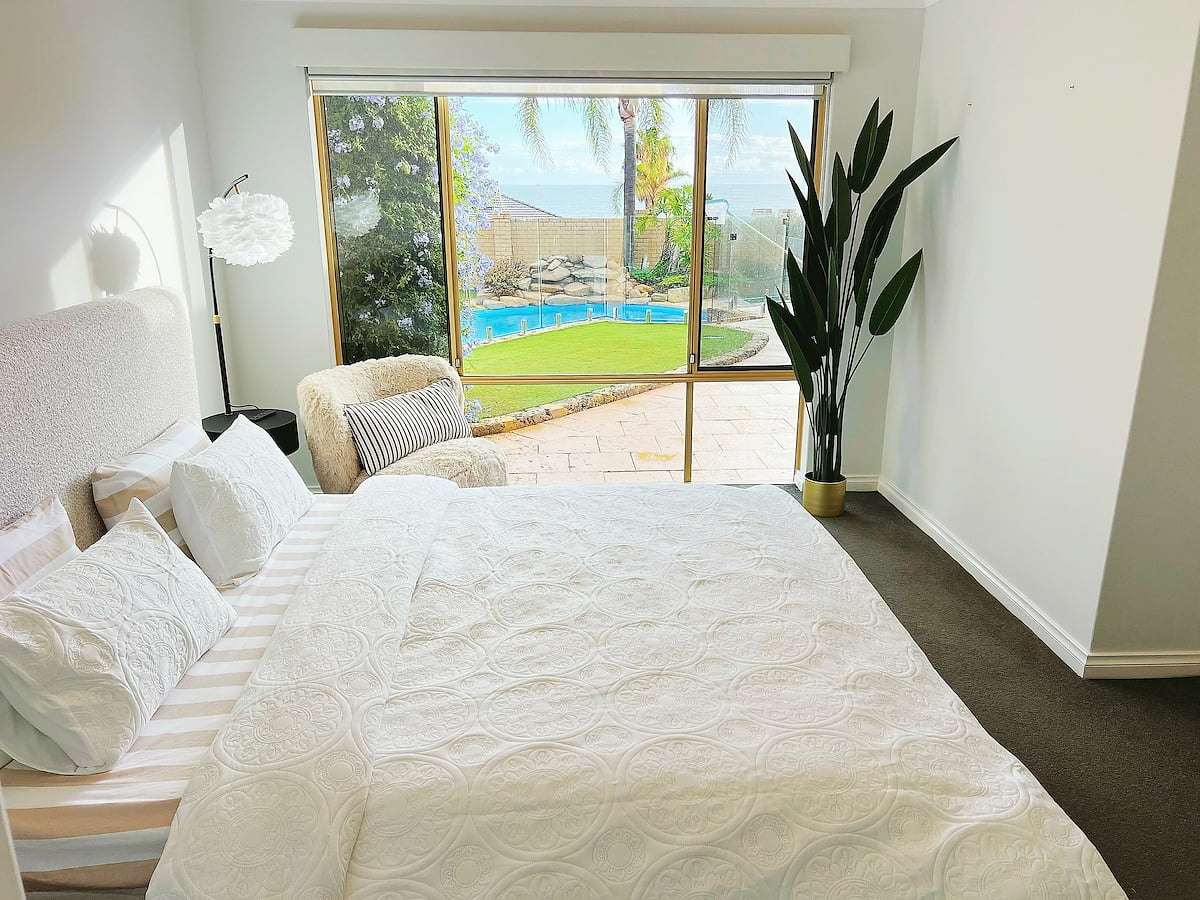 Serene with Ocean & Pool Views, allowing you to wake up to serene waters every morning. Indulge in the ultimate comfort of a super king-size bed, where the calming white decor promotes deep relaxation and a peaceful night's sleep.
