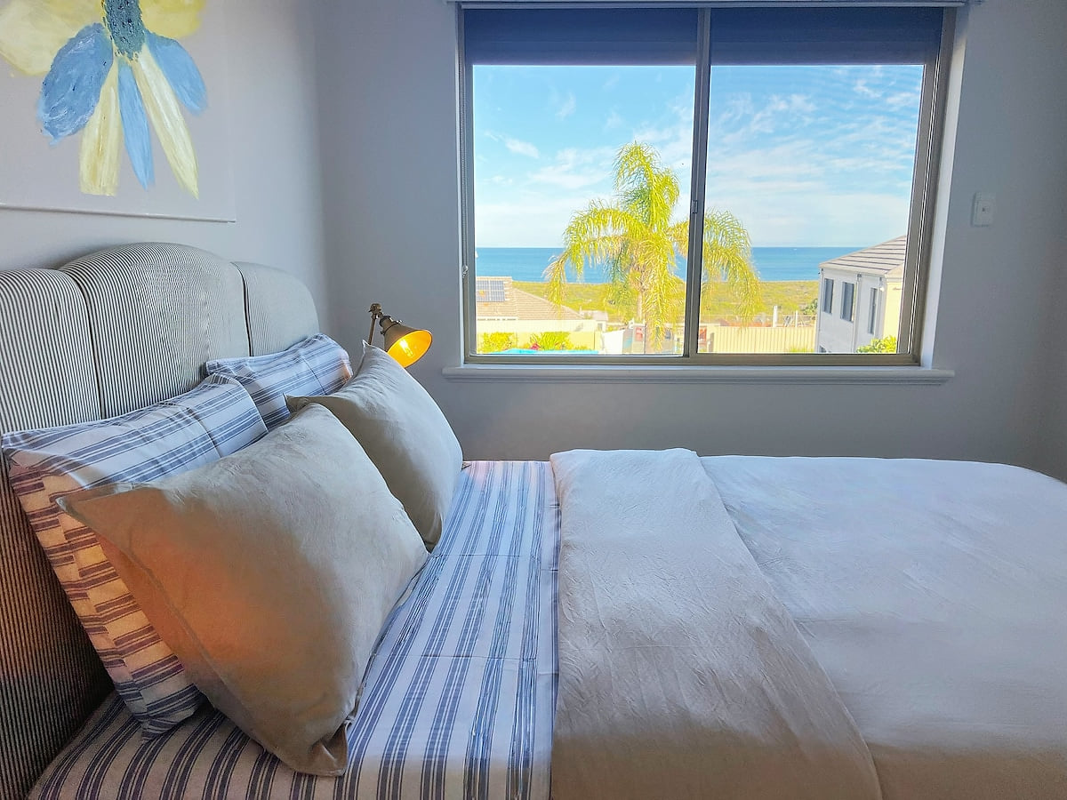 On the First floor, Bedroom 3 offers a serene escape with its captivating palm tree and ocean theme. Sink into the comfort of a queen-size bed and feel completely at one with nature, surrounded by decor that evokes the beauty of the seaside.