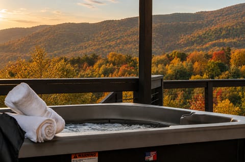 Soak in the hot tub while taking in sweeping fall mountain views and a peaceful golden-hour sunset.