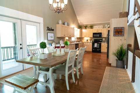 The dining room is open to the kitchen and the French Doors open to the deck.