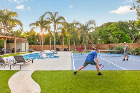 Private backyard oasis with a pool, dedicated pickleball court, and plenty of room for the whole group to play and unwind.