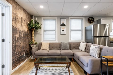 Bright and inviting living room with a spacious sectional, stylish city-inspired décor, and plenty of comfortable seating—the perfect spot to relax and unwind after a day of exploring.