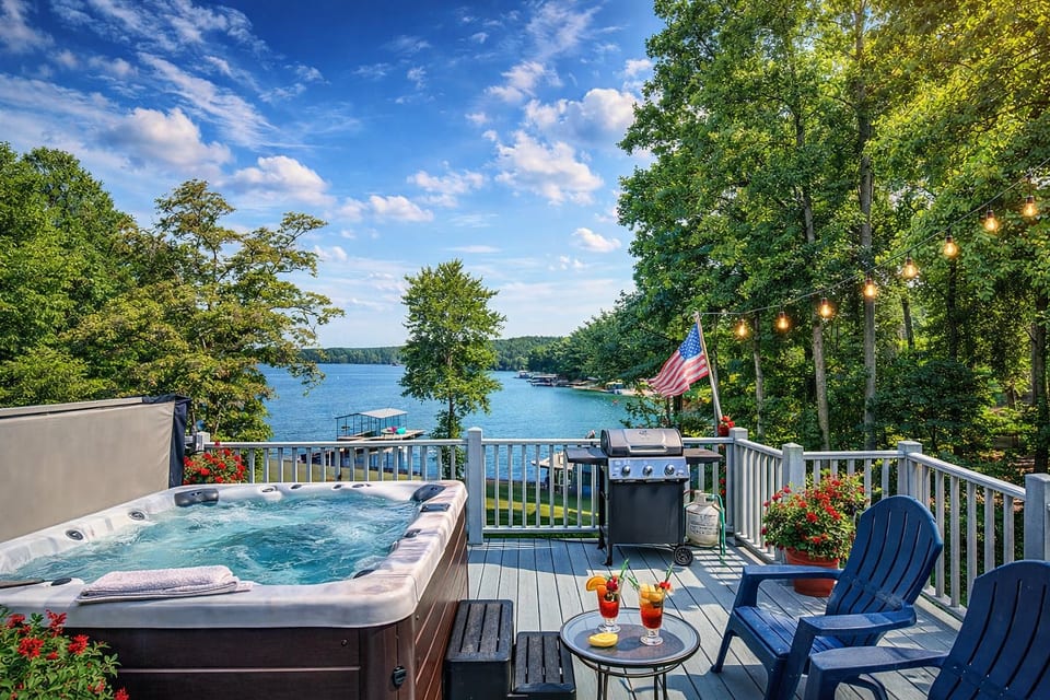 Lakeside deck with hot tub, grill & string lights—relax with a view.