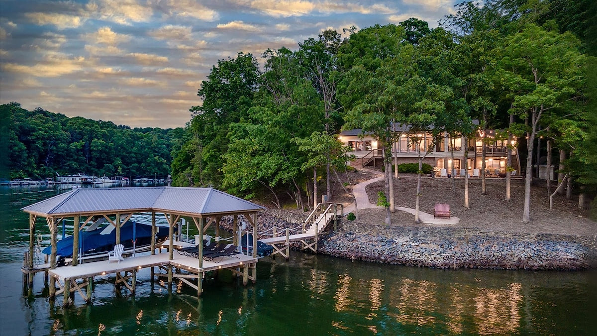 View from the water of the dock and lake house at sunset
