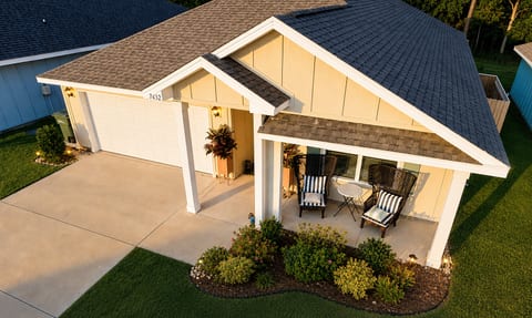 Charming home with covered porch seating and beautiful curb appeal