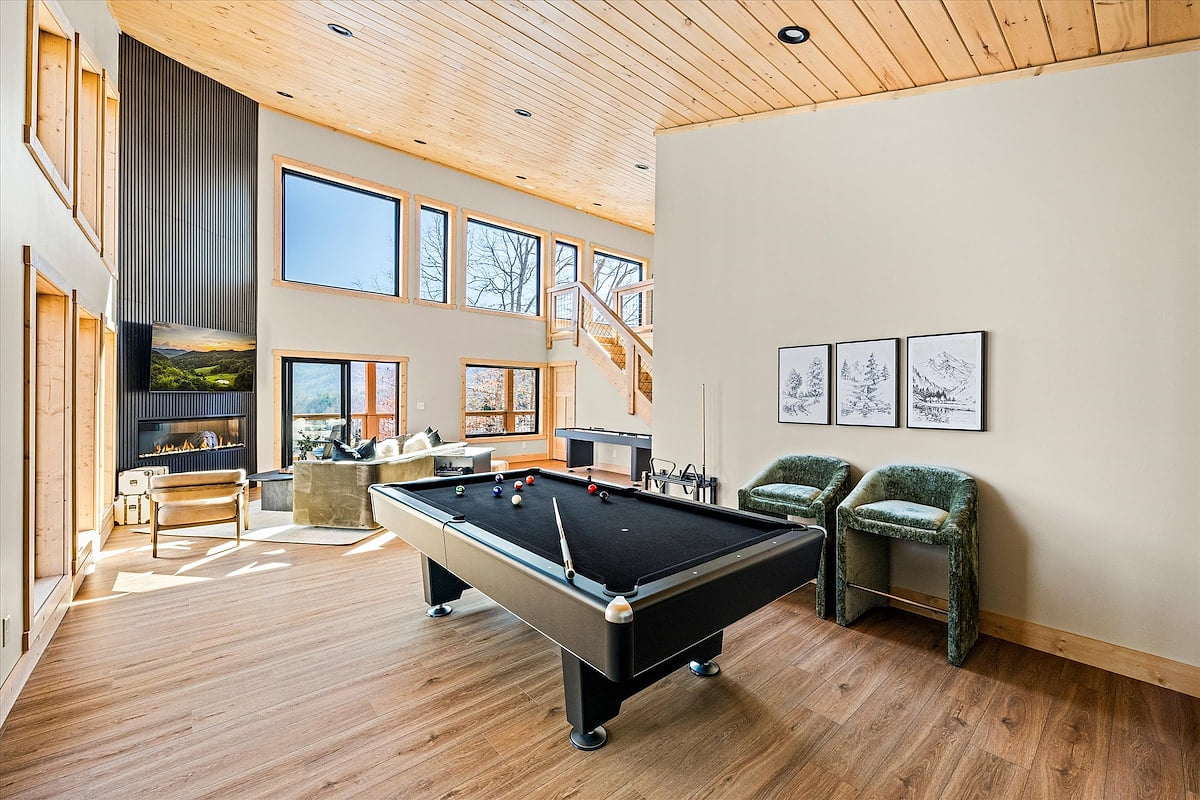 A game room with bar, pool table, shuffleboard table, wall games, board games, and more!