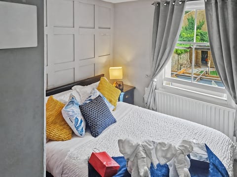 Bright, stylish double room with paneled wall, garden view and swan towels