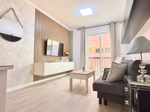 Bright modern lounge with balcony access, wood-slat wall and comfy sofa