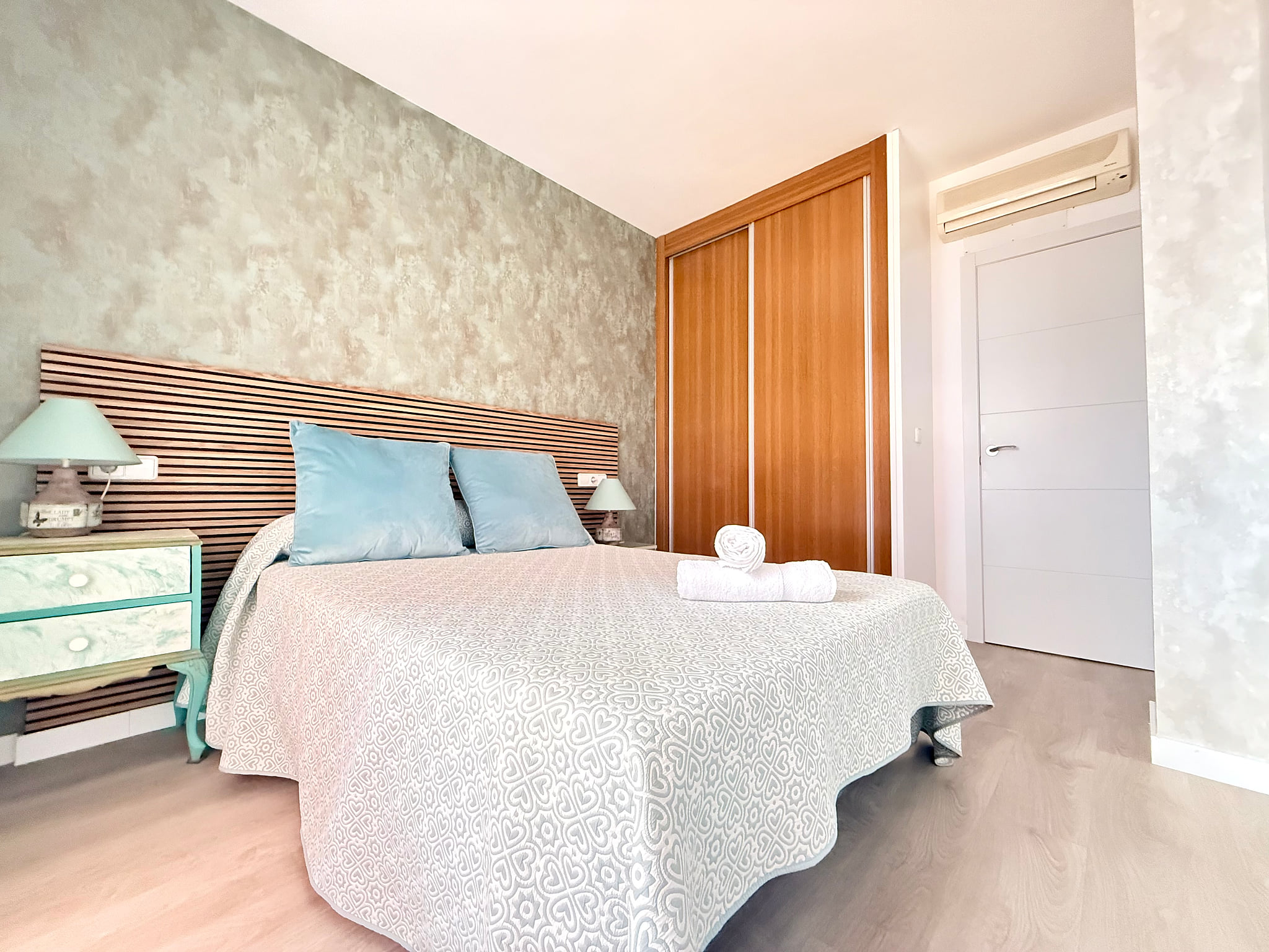 Serene bedroom with AC, built-in closet, and fresh linens