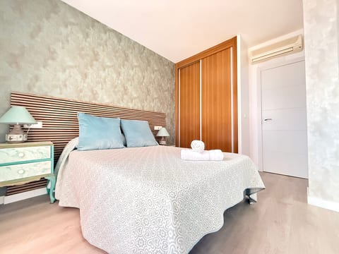 Serene bedroom with AC, built-in closet, and fresh linens