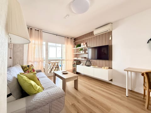 Sunny living room with balcony, smart TV, AC and chic wood accents