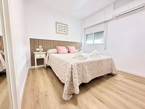 Bright bedroom with AC, slat accent wall, comfy queen bed & fresh linens