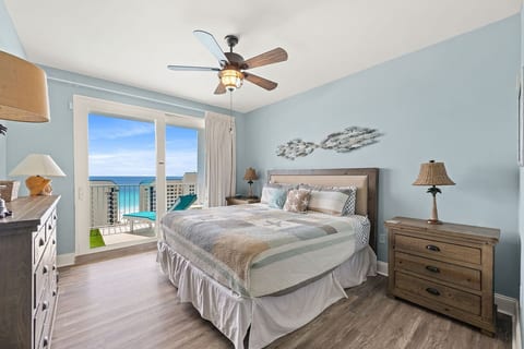 Gulf-view primary bedroom with king bed, balcony access, and relaxing coastal décor.
