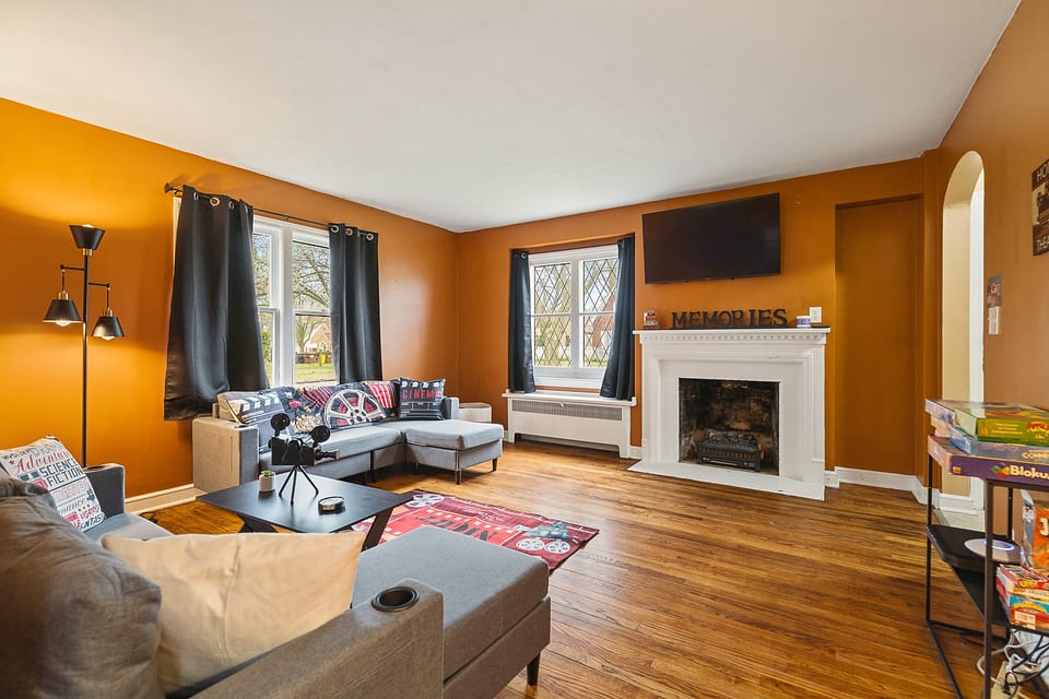 Cozy lounge with fireplace, smart TV, games & sunny windows