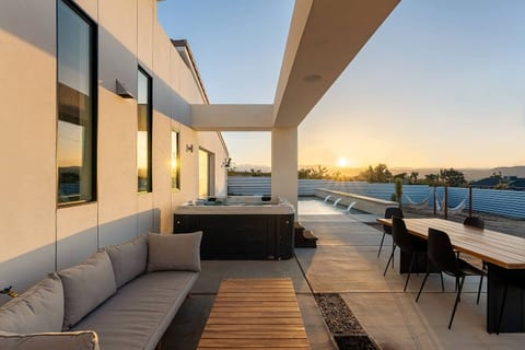Unwind in the hot tub as the desert sun melts into the horizon — golden hour is pure magic here.